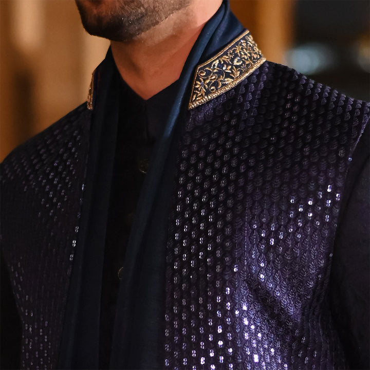 Blue leaf-design embroidered waistcoat paired with teal blue raw silk stole